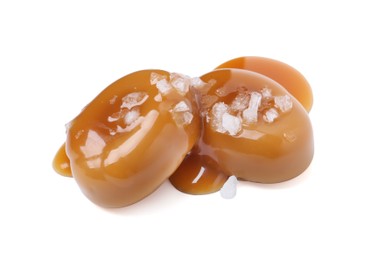 Photo of Tasty sweet candies, salt and caramel sauce isolated on white