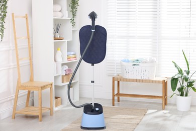 Photo of Modern upright steaming system and furniture at home