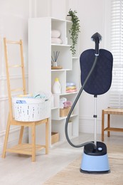 Photo of Modern upright steaming system and furniture at home