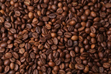 Photo of Aromatic coffee beans as background, top view