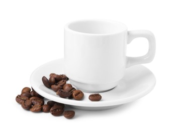 Photo of Aromatic coffee beans, cup and saucer isolated on white