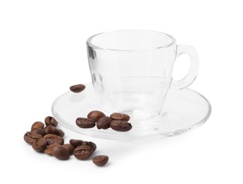 Photo of Aromatic coffee beans, cup and saucer isolated on white