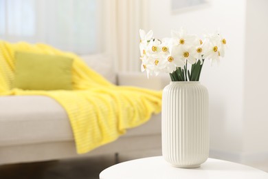 Photo of Beautiful daffodils in vase on white table at home, space for text
