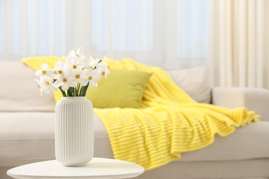 Photo of Beautiful daffodils in vase on white table at home, space for text