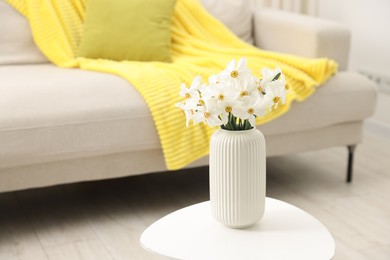 Photo of Beautiful daffodils in vase on white table at home, space for text