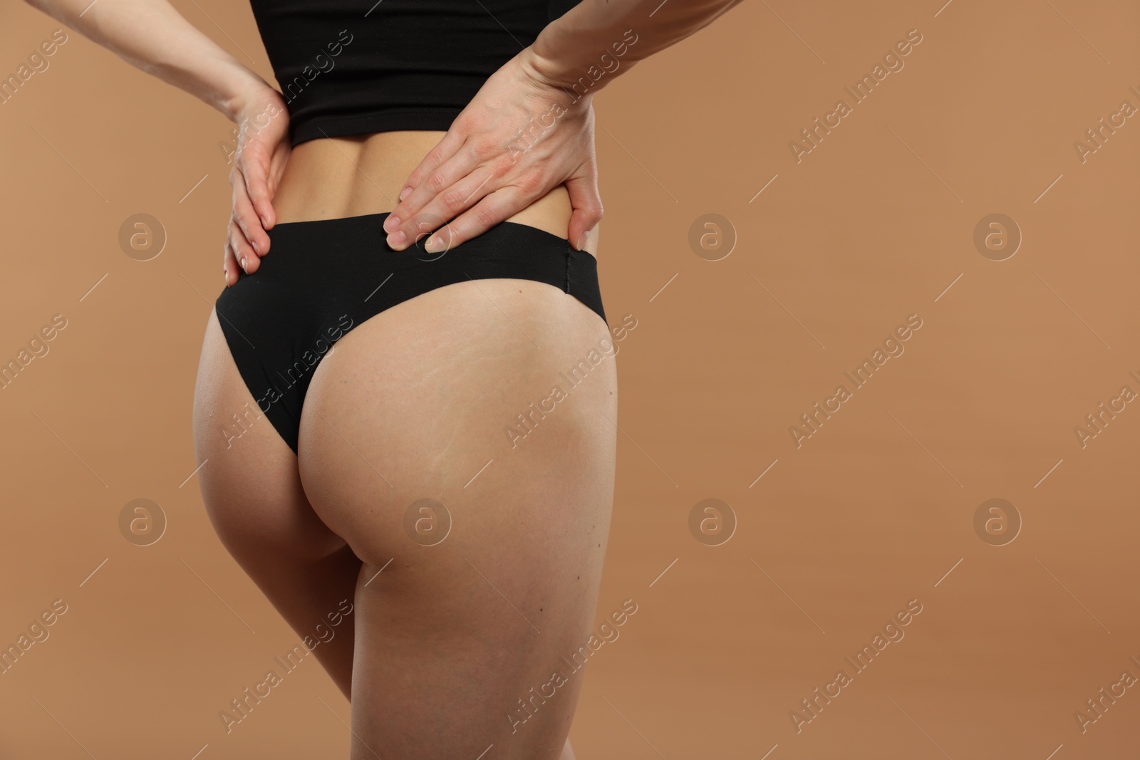 Photo of Woman with perfect slim body on beige background, closeup. Space for text