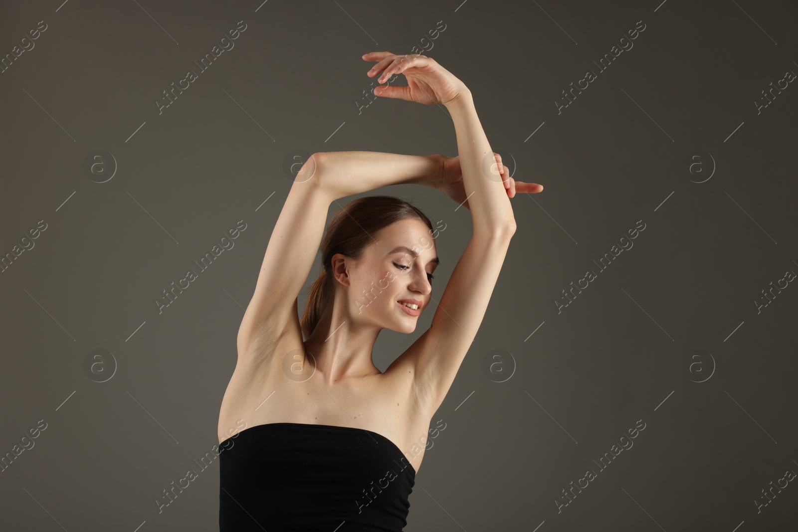 Portrait of beautiful young woman on grey background Photo of Portrait of beautiful young woman on grey background