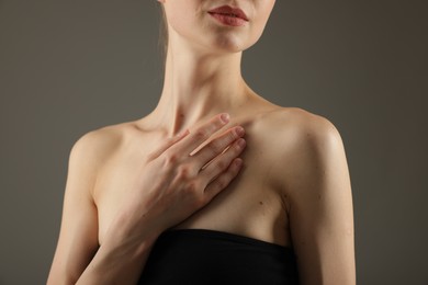 Photo of Woman with perfect slim body on grey background, closeup