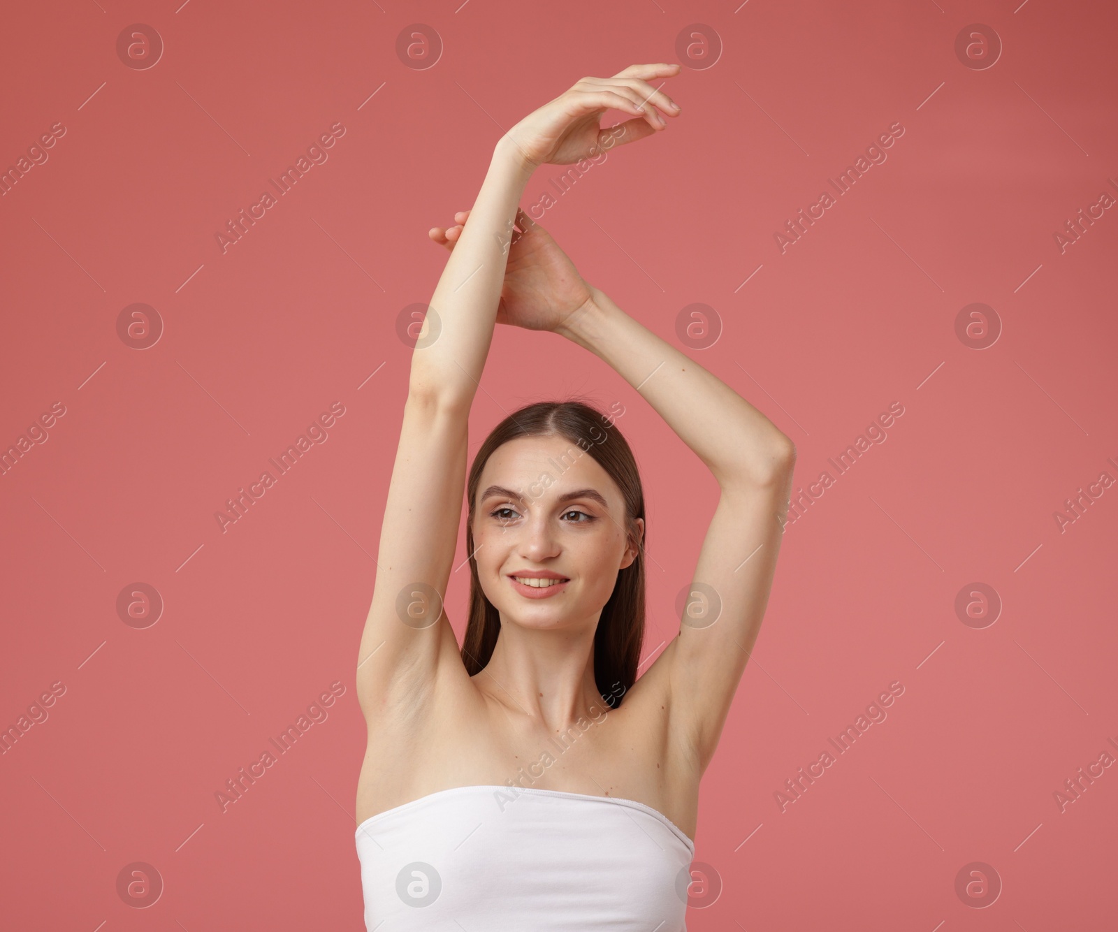Photo of Portrait of beautiful young woman on pink background