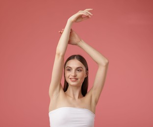 Photo of Portrait of beautiful young woman on pink background