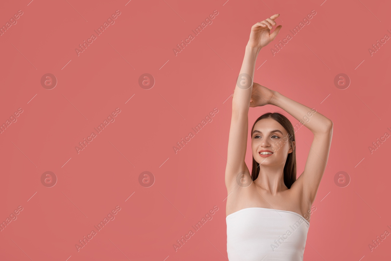Photo of Portrait of beautiful young woman on pink background. Space for text