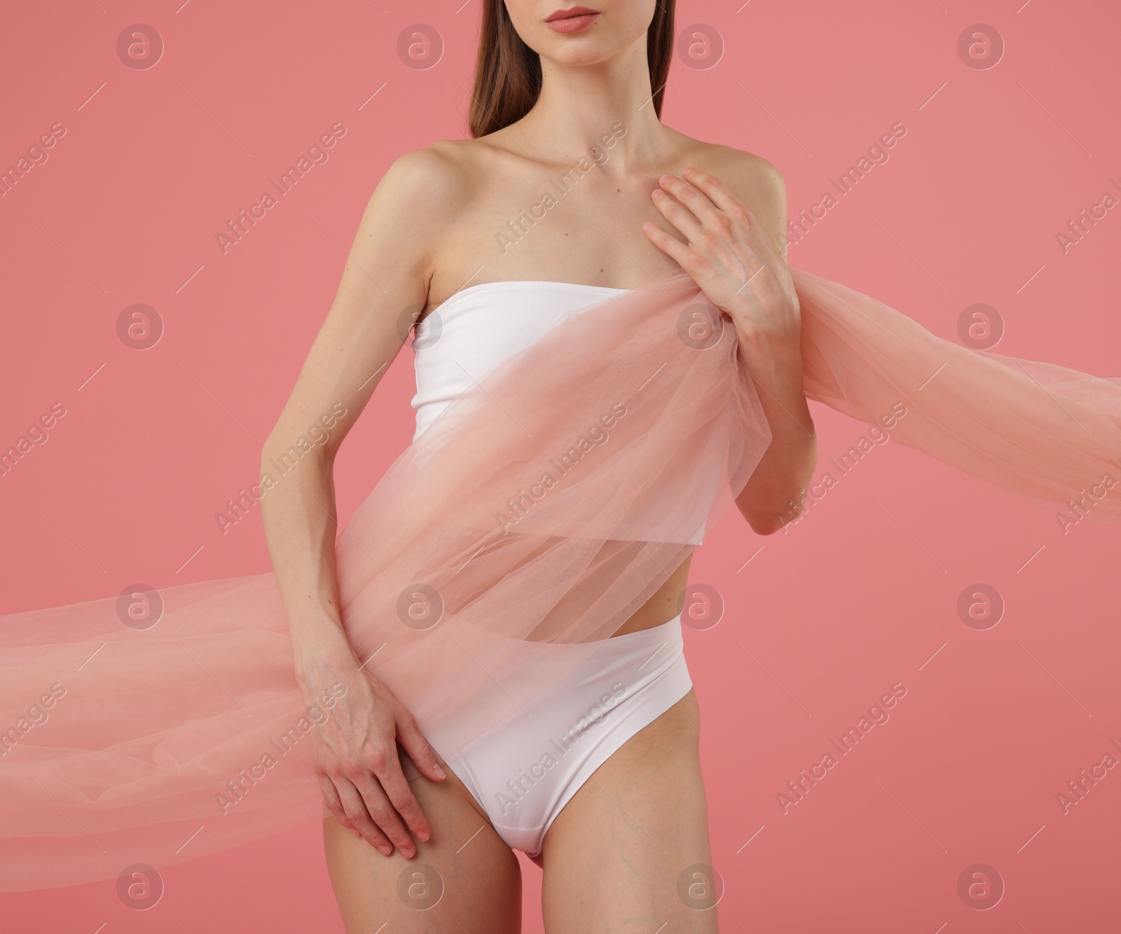 Photo of Young woman with beautiful fabric on pink background, closeup
