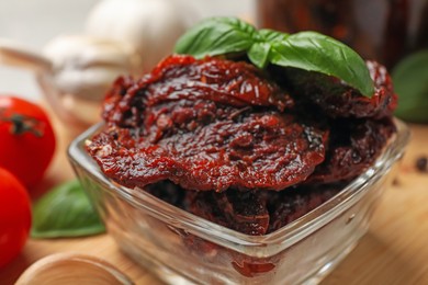 Photo of Delicious sun dried tomatoes on wooden table, closeup