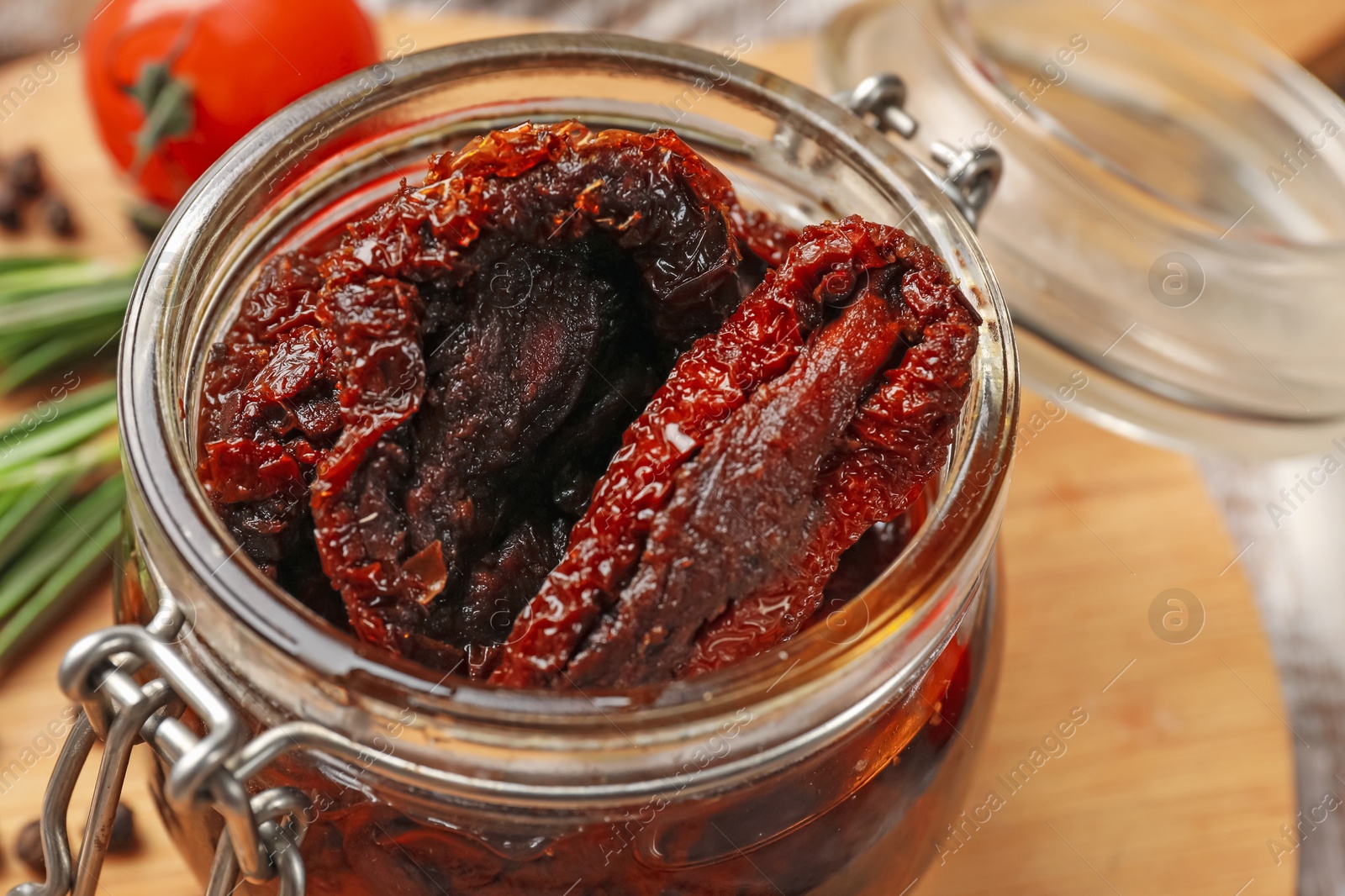 Delicious sun dried tomatoes in jar on table, closeup Photo of Delicious sun dried tomatoes in jar on table, closeup