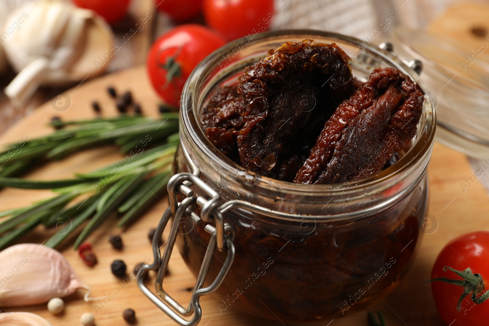 Delicious sun dried tomatoes in jar on table, closeup Photo of Delicious sun dried tomatoes in jar on table, closeup