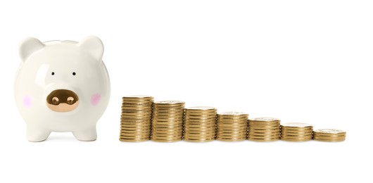 Image of Piggy bank and stacks of coins from bigger to smaller on white background