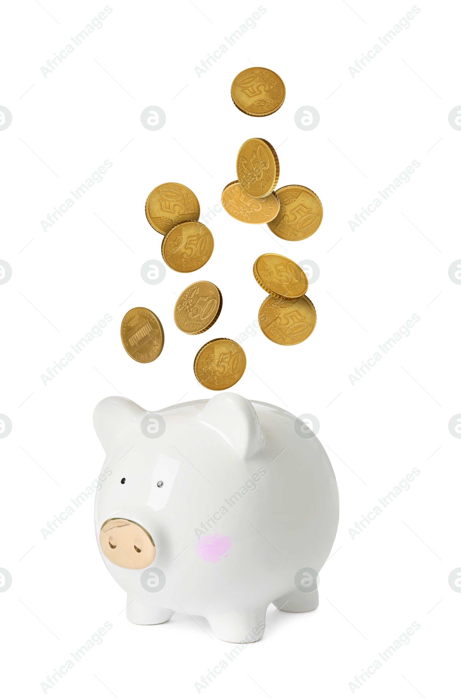 Coins falling into piggy bank on white background Image of Coins falling into piggy bank on white background