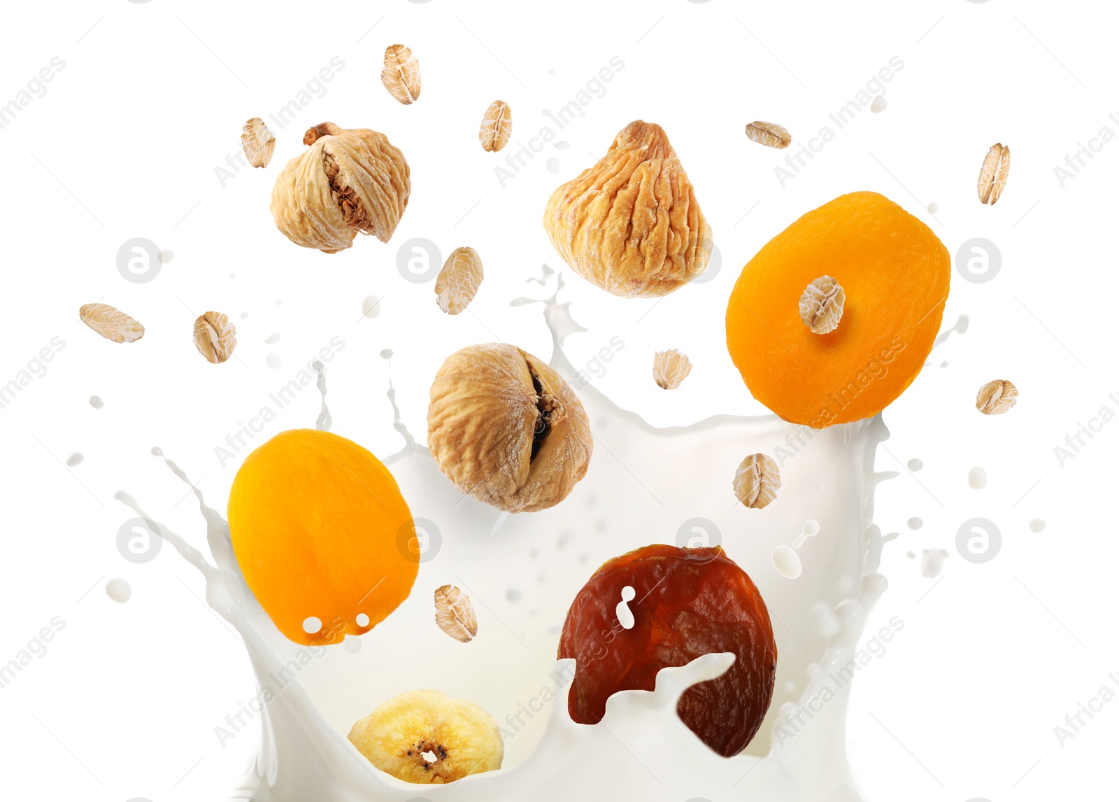 Milk splash with oat flakes and dried fruits in air on white background. Healthy breakfast Image of Milk splash with oat flakes and dried fruits in air on white background. Healthy breakfast