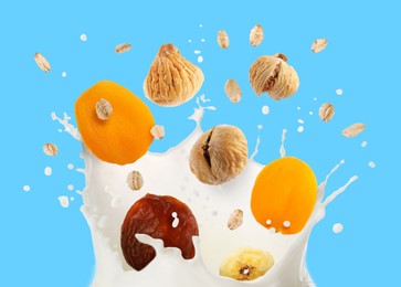 Image of Milk splash with oat flakes and dried fruits in air on light blue background
