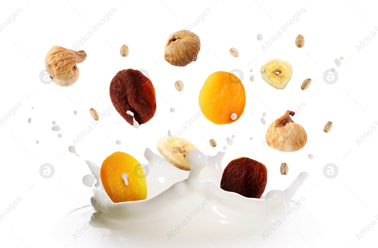 Milk splash with oat flakes and dried fruits in air on white background. Healthy breakfast Image of Milk splash with oat flakes and dried fruits in air on white background. Healthy breakfast
