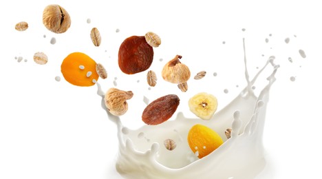 Image of Milk splash with oat flakes and dried fruits in air on white background. Healthy breakfast