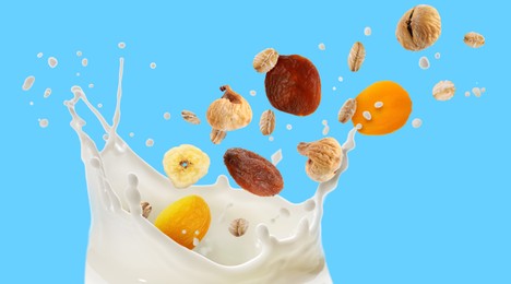 Image of Milk splash with oat flakes and dried fruits in air on light blue background. Banner design