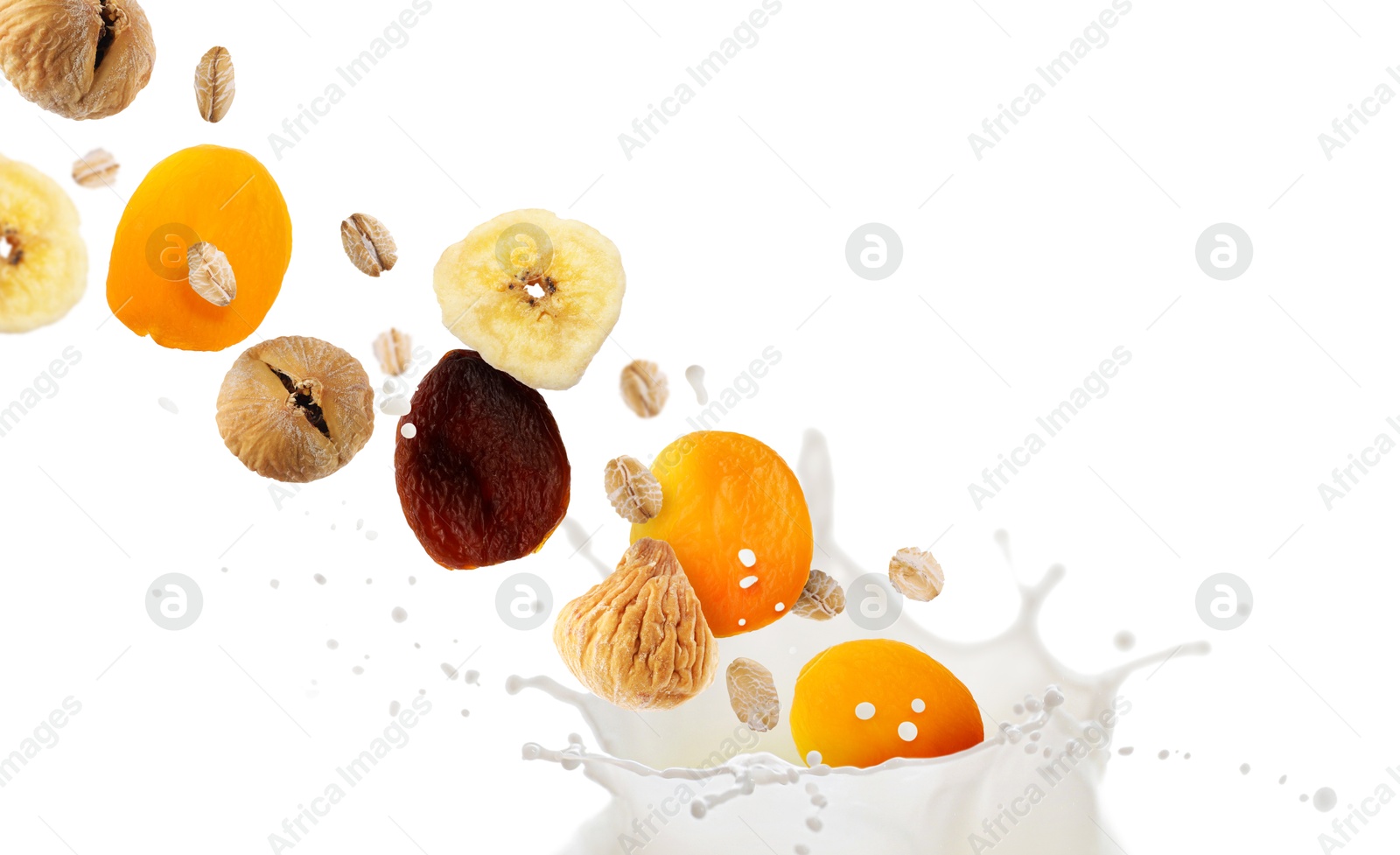 Milk splash with oat flakes and dried fruits in air on white background. Healthy breakfast Image of Milk splash with oat flakes and dried fruits in air on white background. Healthy breakfast