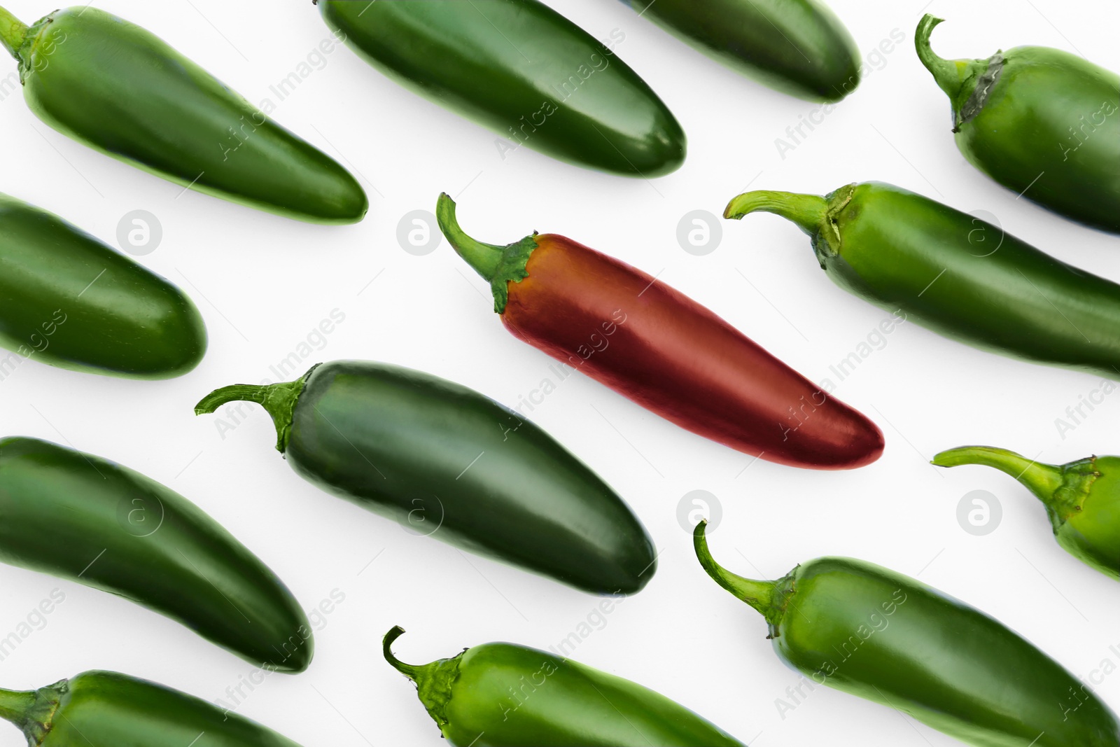 Individuality, uniqueness, different. Red pepper among green ones on white background, flat lay Image of Individuality, uniqueness, different. Red pepper among green ones on white background, flat lay