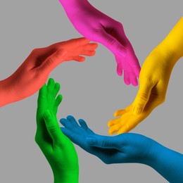 Image of Making circle of human hands painted in different colors on grey background. Unity, partnership, cooperation