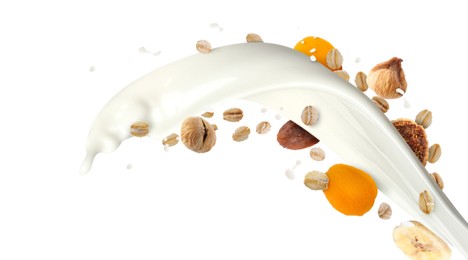 Image of Milk splash with oat flakes and dried fruits in air on white background. Healthy breakfast