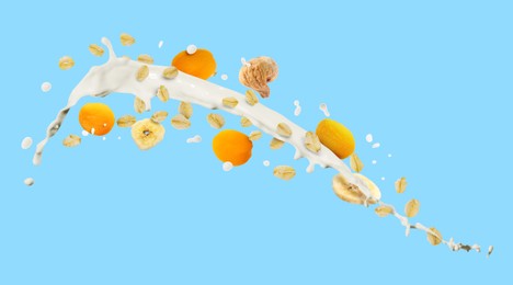 Image of Milk splash with oat flakes and dried fruits on light blue background. Banner design