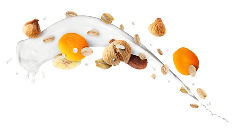Image of Milk splash with oat flakes and dried fruits in air on white background. Healthy breakfast