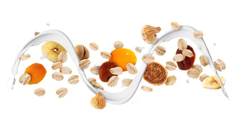 Image of Milk flow with oat flakes and dried fruits in air on white background. Healthy breakfast