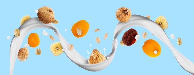 Image of Milk flow with oat flakes and dried fruits on light blue background. Banner design