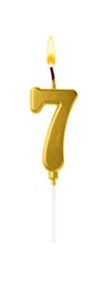 Image of Golden cake candle in shape of number 7 burning on white background. Festive decoration for birthday or other special date
