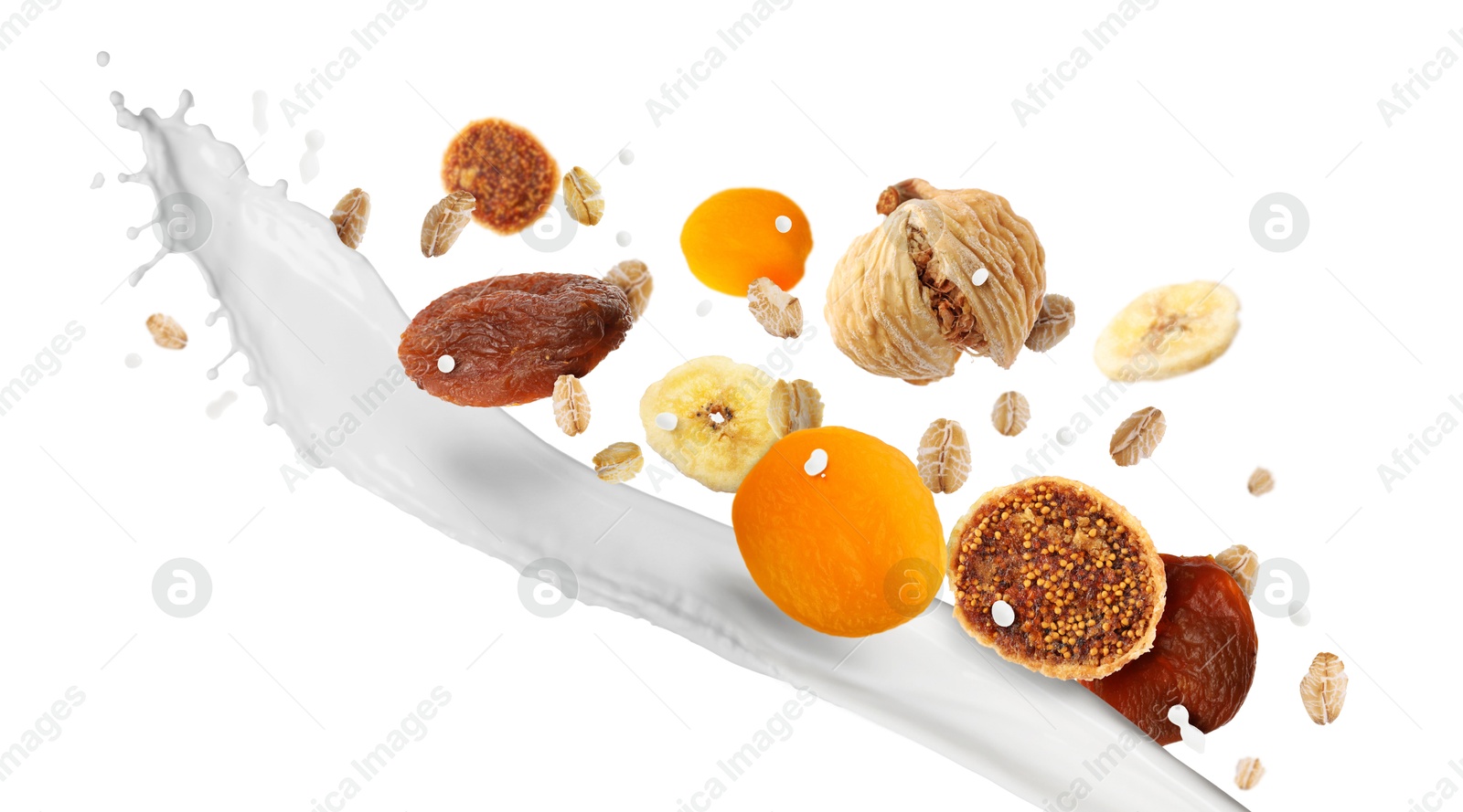 Milk splash with oat flakes and dried fruits in air on white background. Healthy breakfast Image of Milk splash with oat flakes and dried fruits in air on white background. Healthy breakfast