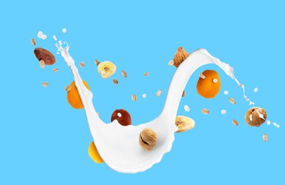 Image of Milk splash with oat flakes and dried fruits on light blue background. Banner design