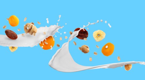 Image of Milk splash with oat flakes and dried fruits on light blue background. Banner design