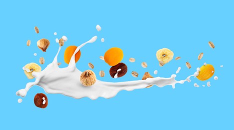 Image of Milk splash with oat flakes and dried fruits on light blue background. Banner design