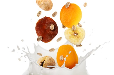 Image of Milk splash with oat flakes and dried fruits in air on white background. Healthy breakfast