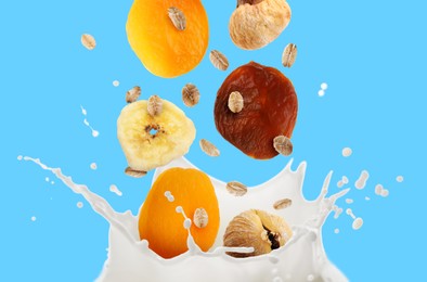 Image of Milk splash with oat flakes and dried fruits in air on light blue background