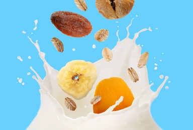 Image of Milk splash with oat flakes and dried fruits in air on light blue background