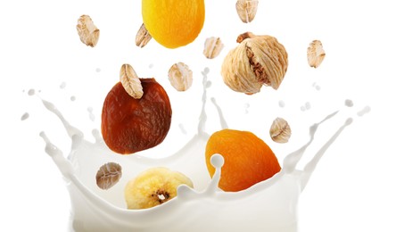Image of Milk splash with oat flakes and dried fruits in air on white background. Healthy breakfast