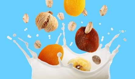 Image of Milk splash with oat flakes and dried fruits in air on light blue background. Banner design