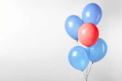 Image of Individuality, uniqueness, different. Red balloon among blue ones on white background