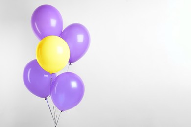 Image of Individuality, uniqueness, different. Yellow balloon among purple ones on white background