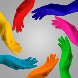 Image of Making circle of human hands painted in different colors on grey background. Unity, partnership, cooperation