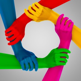 Image of Making circle of human hands painted in different colors on grey background. Unity, partnership, cooperation