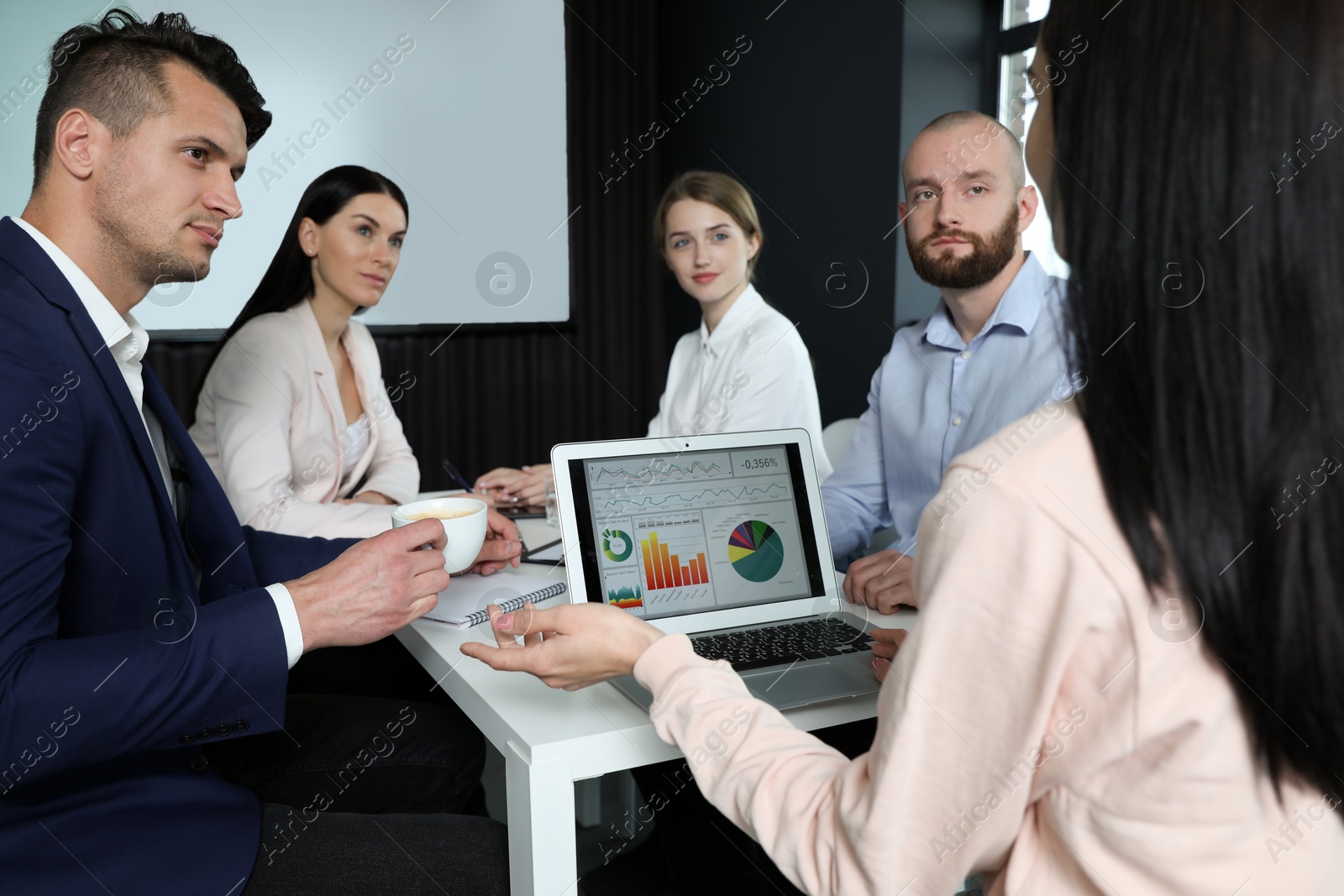 Business people having meeting in conference room with video projection screen Photo of Business people having meeting in conference room with video projection screen