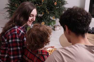 Photo of Family spending time together at home. Watching movie via video projector